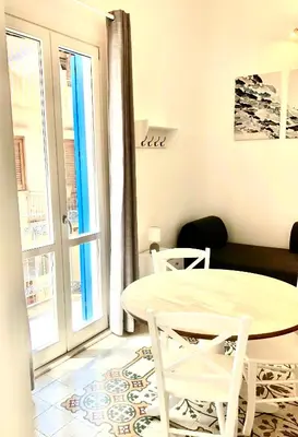 a small living room with a table and chairs at Casa Colore Loft in Castellammare del Golfo