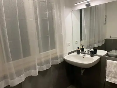 a bathroom with a sink and a mirror at Quattro Canti al Cassaro in Palermo
