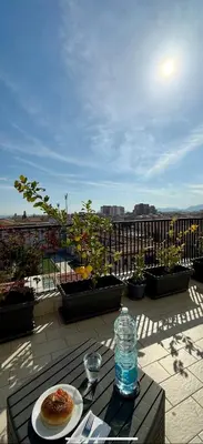 a table with a plate of food and a bottle of water at B&B Bellavista in Palermo