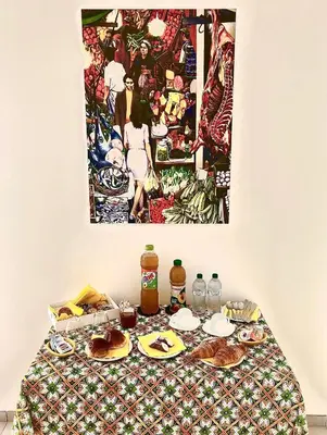 a table with food on it with a picture on the wall at B&B Bellavista in Palermo