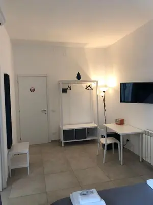 a living room with a table and a tv at B&B Bellavista in Palermo