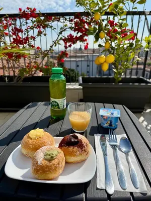 two donuts on a plate on a table at B&B Bellavista in Palermo