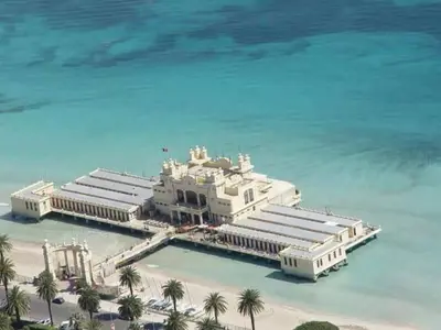 a large white building in the middle of the ocean at mondello lilla' room in Palermo
