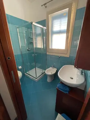 a bathroom with a shower and a sink and a toilet at NEREA - Appartamento fronte mare in San Vito lo Capo