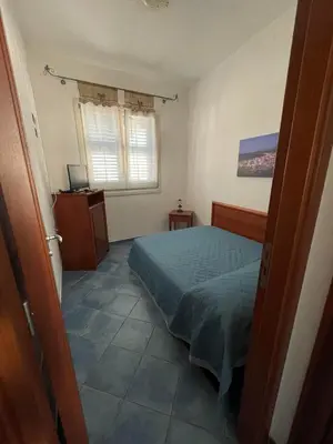 a bedroom with a bed and a window at NEREA - Appartamento fronte mare in San Vito lo Capo