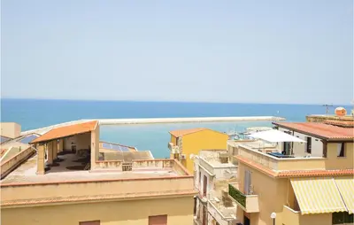 a view of the ocean from the roofs of buildings at Cozy Apartment In Balestrate With Wifi in Balestrate