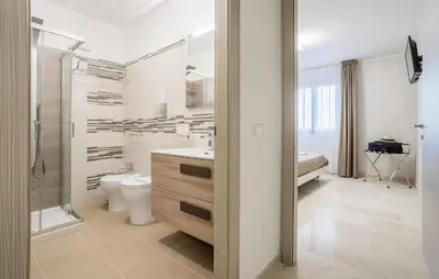 a bathroom with a toilet sink and a shower at Cozy Apartment In Balestrate With Wifi in Balestrate