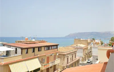 a view of a city with buildings and the ocean at Beautiful Apartment In Balestrate in Balestrate