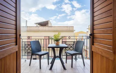 a patio with a table and chairs on a balcony at Beautiful Apartment In Balestrate in Balestrate