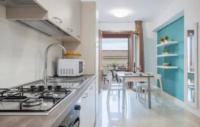 a kitchen with a stove and a table with chairs at Beautiful Apartment In Balestrate in Balestrate
