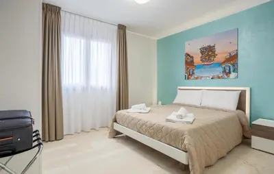 a bedroom with a bed and a television in it at Beautiful Apartment In Balestrate in Balestrate