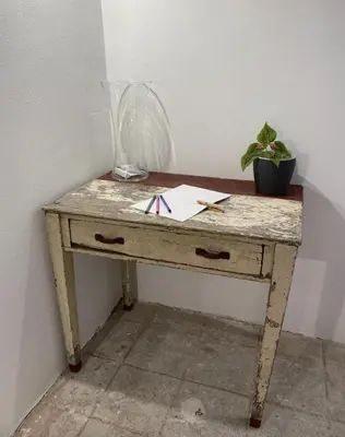 a wooden table with a paper and a plant on it at Patio1861 - A Sicilian deluxe apartment in Termini Imerese