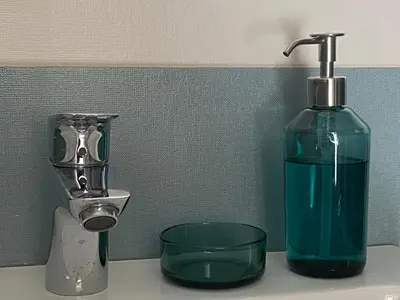 a soap dispenser and a bottle on a sink at Patio1861 - A Sicilian deluxe apartment in Termini Imerese