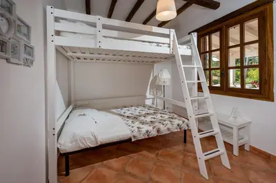 a bedroom with a bunk bed and a ladder at NUOVA Villa Intera Guidaloca in Scopello