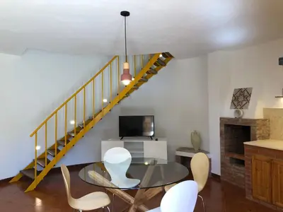 a dining room with a glass table and chairs at TORRE MARIZA Guidaloca in Scopello
