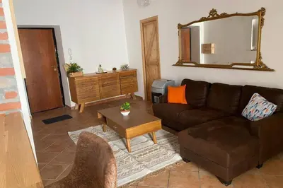 a living room with a couch and a table at Casaescape City in Palermo