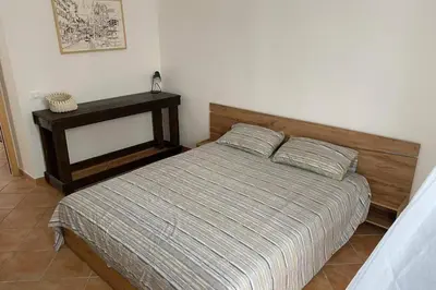 a bedroom with a bed and a night stand at Casaescape City in Palermo