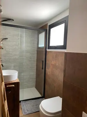 a bathroom with a shower and a toilet and a sink at Casaescape City in Palermo