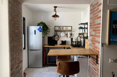a kitchen with a white refrigerator and a table at Casaescape City in Palermo