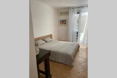 a bedroom with a bed and a table and a window at Casaescape City in Palermo
