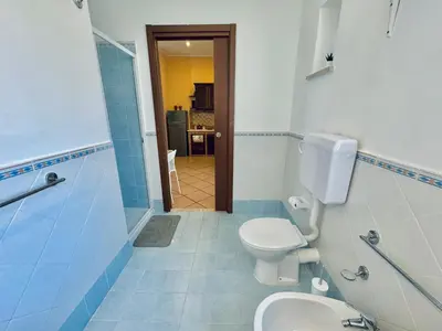 a bathroom with a toilet and a sink at Le Maioliche in Sferracavallo