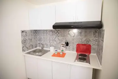 a small kitchen with a sink and a microwave at Isola bella in Isola delle Femmine