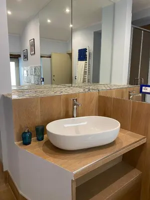 a bathroom with a white sink and a mirror at La casetta di Maria alla Ciba in Termini Imerese