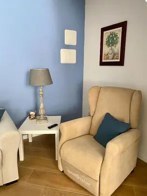 a living room with a couch and a table with a lamp at La casetta di Maria alla Ciba in Termini Imerese
