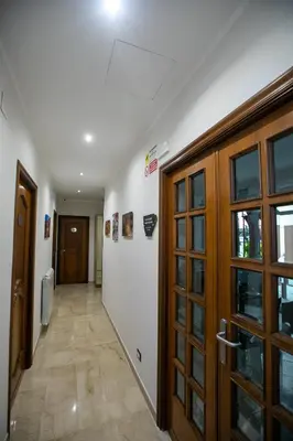 a hallway with wooden doors and a hallway with at B&B Azul in Palermo