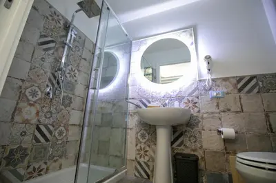 a bathroom with a shower and a sink and a toilet at B&B Azul in Palermo
