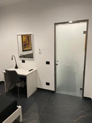 a bathroom with a desk and a door with a mirror at Case vacanze donna Ina in Palermo