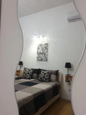 a bedroom with a bed and a mirror at Donizetti 19 in Palermo