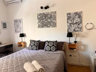 a bedroom with a bed and two pictures on the wall at Donizetti 19 in Palermo