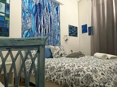 a bedroom with a bed with a blue and white comforter at Donizetti 19 in Palermo