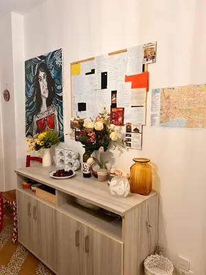 a wooden cabinet with flowers on top of it at Donizetti 19 in Palermo