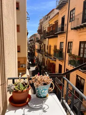 a balcony with two vases sitting on a table at Donizetti 19 in Palermo
