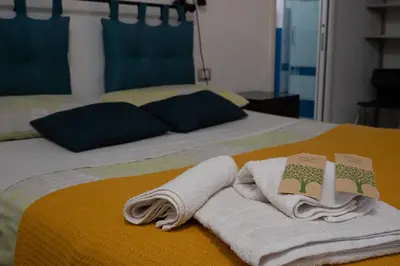 a bed with two towels on top of it at Le Tartarughe di Ro' Casavacanze in Mondello