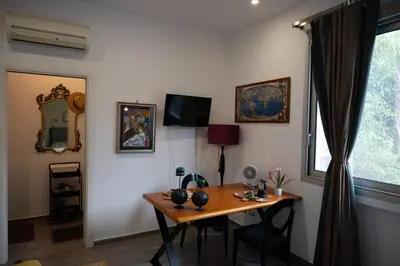a room with a table and a mirror and a window at Le Tartarughe di Ro' Casavacanze in Mondello