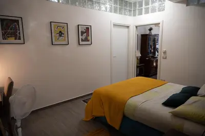a bedroom with a bed with a yellow blanket on it at Le Tartarughe di Ro' Casavacanze in Mondello