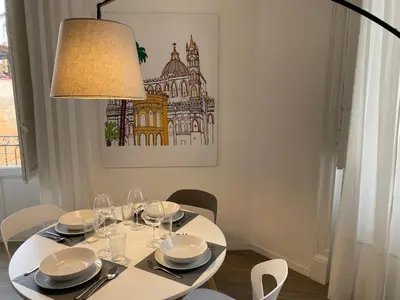 a white dining room table with a lamp and chairs at SuiteInPalermo - case vacanze nel centro storico in Palermo