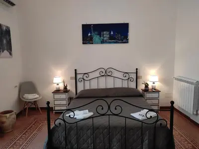 a bedroom with a black bed with two night stands at CASA DEI SOGNI in Palermo