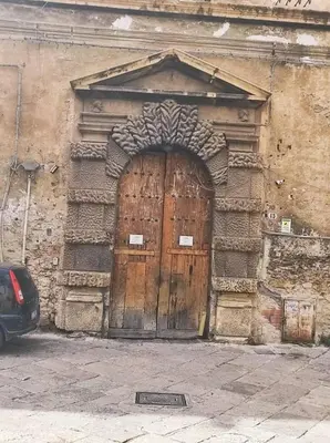 a large wooden door on the side of a building at CASA DEI SOGNI in Palermo