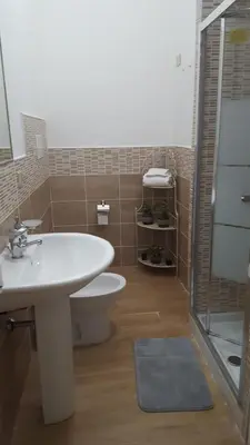 a bathroom with a sink and a toilet and a shower at CASA DEI SOGNI in Palermo