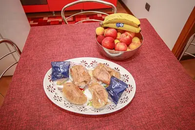 a plate of food on a table with a bowl of fruit at Appartamento con terrazza al centro storico. in Palermo