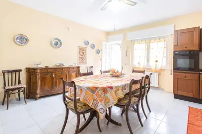 a kitchen and dining room with a table and chairs at Independent Villa Located a few Minutes Walk From the Beach in Quiet Area in Palermo