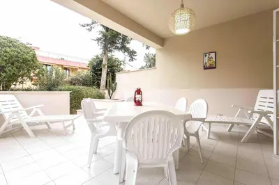 a white table and chairs on a patio at Independent Villa Located a few Minutes Walk From the Beach in Quiet Area in Palermo