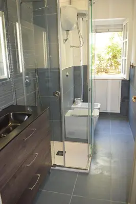 a bathroom with a glass shower and a sink at Independent Villa Located a few Minutes Walk From the Beach in Quiet Area in Palermo
