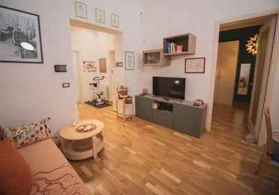 a living room with a couch and a television at Itiseasy Palermo 1 e 2 Private Apartments in Palermo