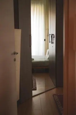 a door leading to a bedroom with a window at Itiseasy Palermo 1 e 2 Private Apartments in Palermo