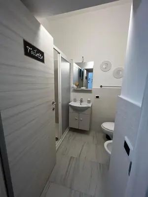 a bathroom with a toilet and a sink at MARINA BAY in Terrasini